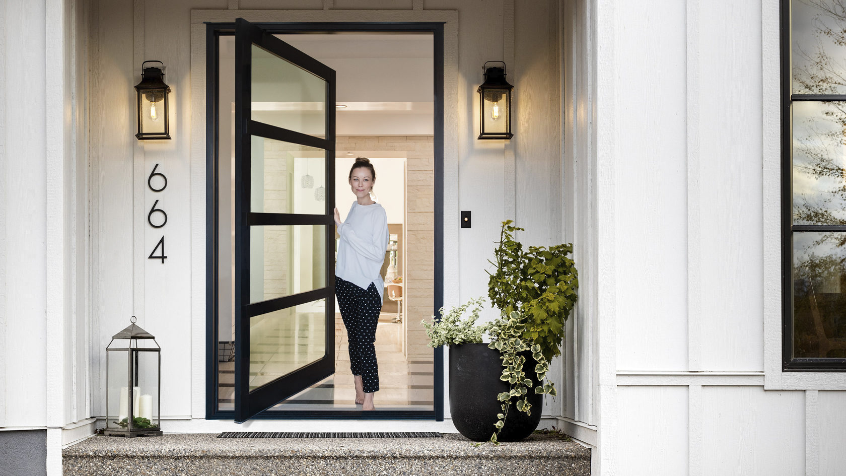 Woman opening her Lux Pivot doorway